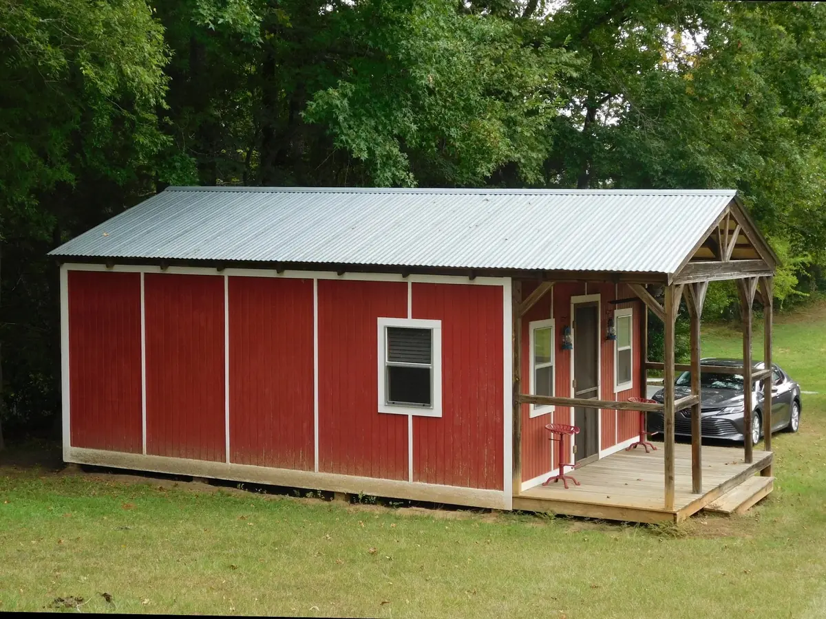 Before: the same barn with its original classic rib metal roof